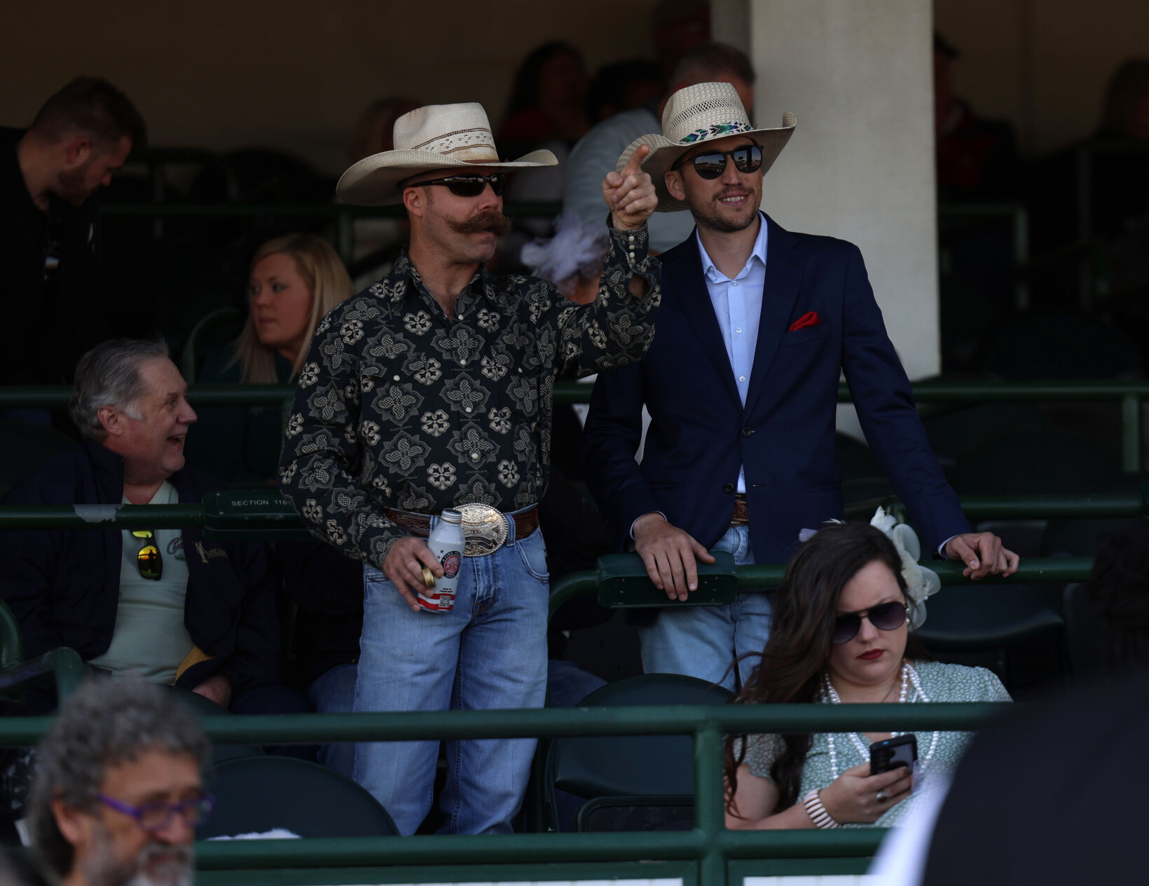 Two men watch a race on Opening Night.JPG